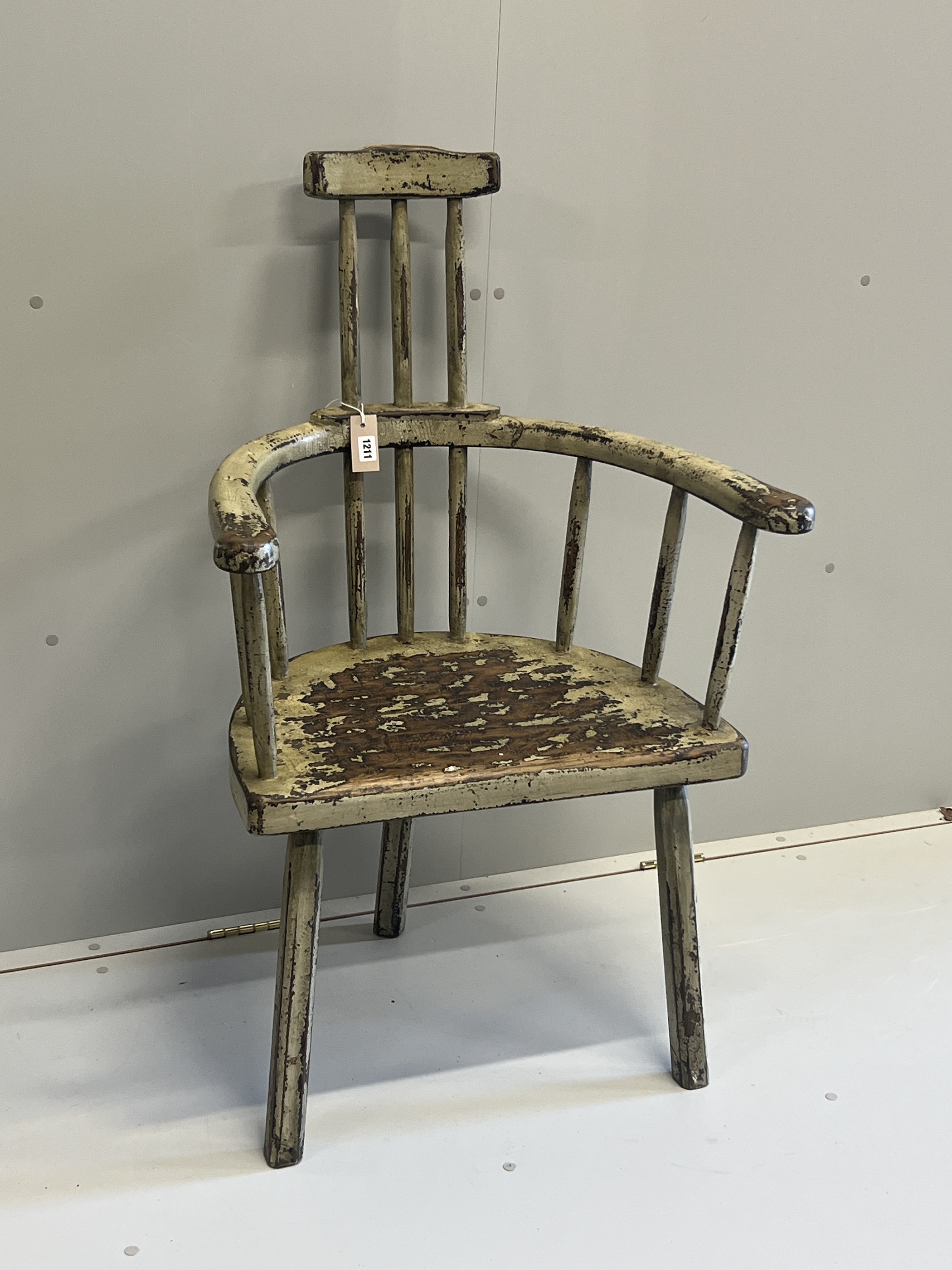 An 18th century style painted hardwood primitive elbow chair, width 68cm, depth 44cm, height 108cm